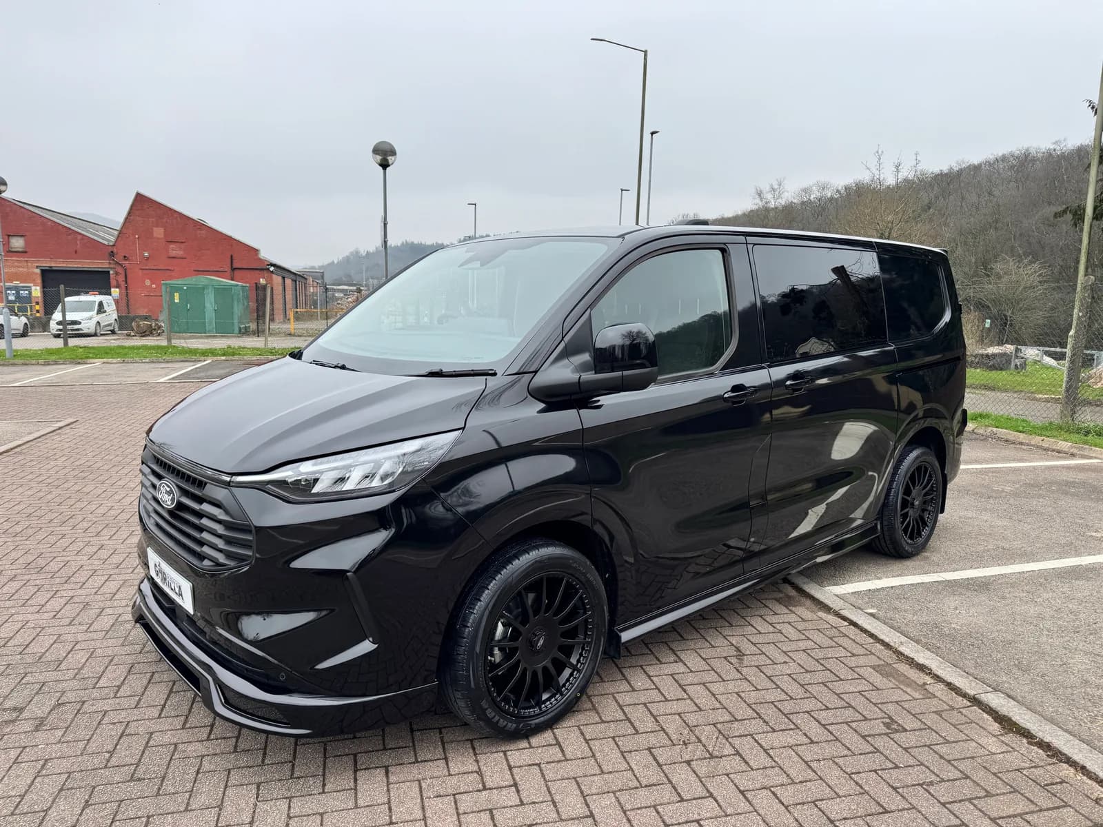 Black L1 Ford Transit Custom GV Sport Double Cab, front three-quarter view
